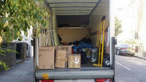 Secure enclosed skip parked on a residential property in Northolt