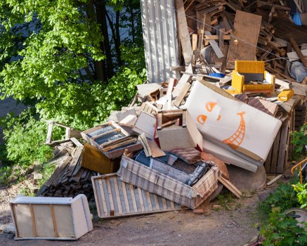 Workers sorting recyclables from a skip near Northolt